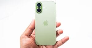 Green smartphone with dual rear cameras held in a person’s hand